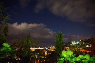 Illuminated cityscape against sky at night