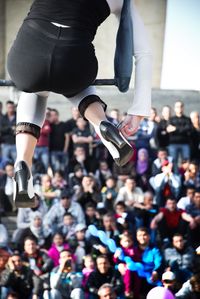 Close-up of woman with spectators in background