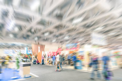 Blurred motion of people walking on road in city