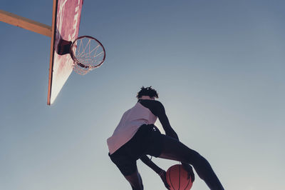 Low angle view of basketball hoop against clear sky