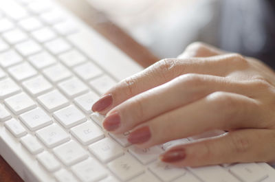 Cropped hands using laptop