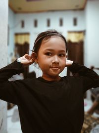 Portrait of young woman drinking water