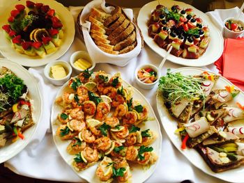 High angle view of various food in plates on table