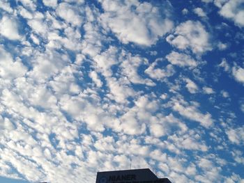 Low angle view of building against cloudy sky