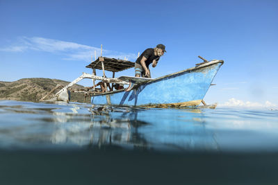 Male surfer in a boat