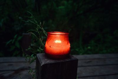 Close-up of drink on wooden post