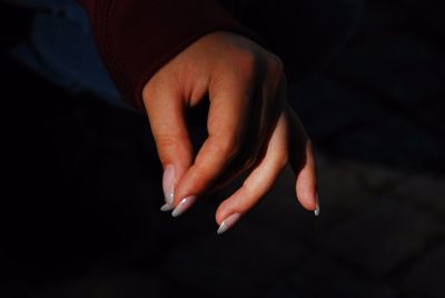 Close-up of person hand over black background