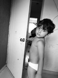 Portrait of shirtless boy standing at home