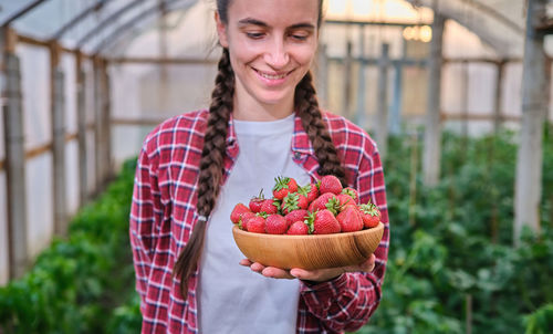 Portrait of woman holding food