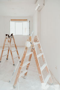 Ladders on white room at construction site. painting walls. home improvement, renovation