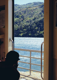 Man looking through window