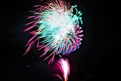 Low angle view of firework display at night