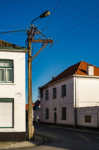 Empty road along built structures