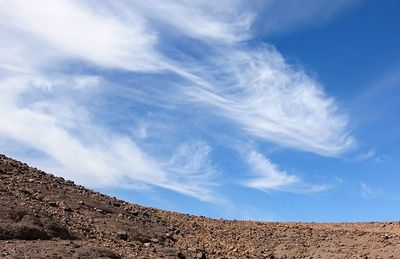 Low angle view of mountain against blue sky