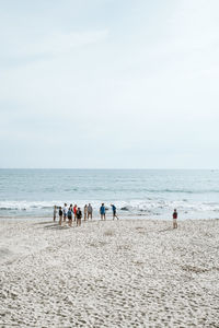 People on beach against sky