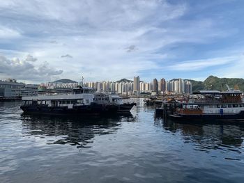Buildings by sea against sky in city
