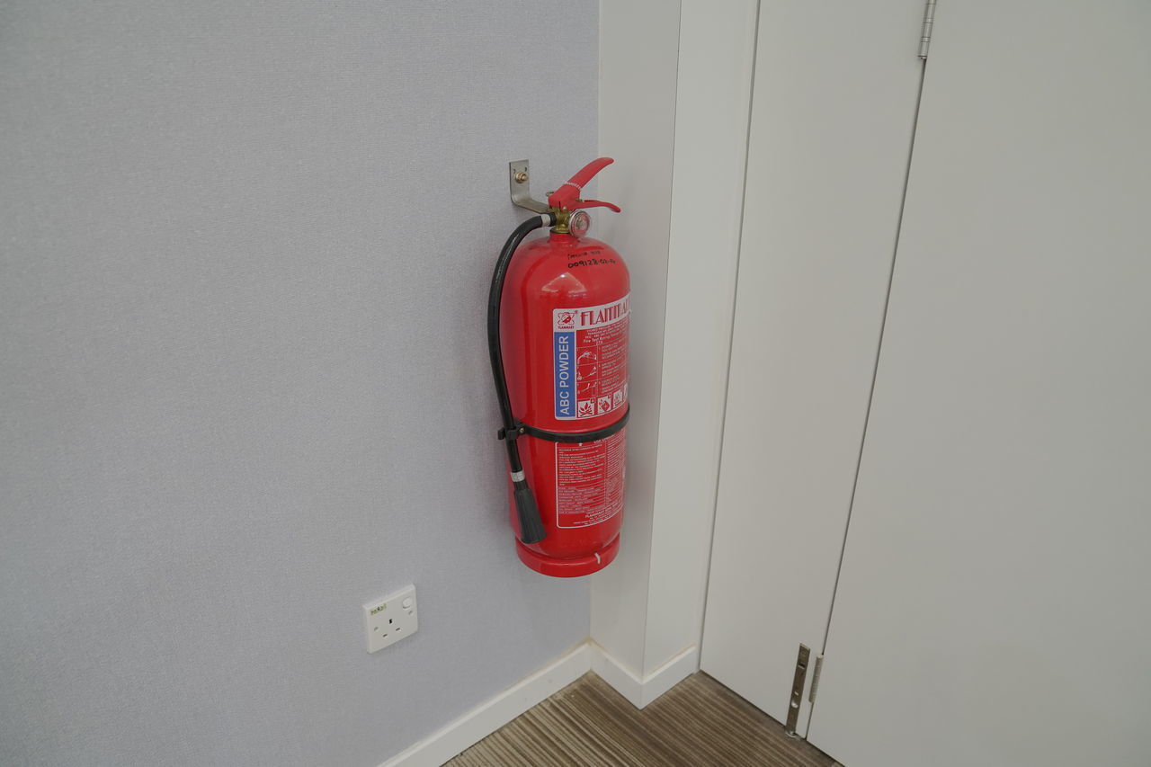 RED TEXT ON WALL WITH TOY