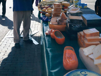 Low section of woman standing by food for sale