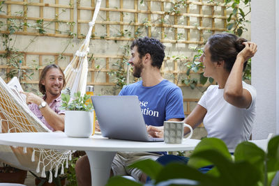 Friends using laptop at home