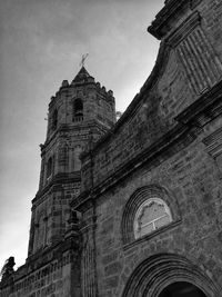 Low angle view of bell tower against sky