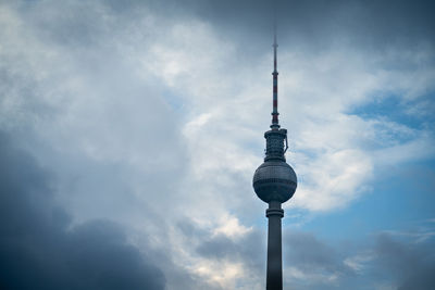 Low angle view of communications tower against sky