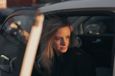 Portrait of young woman in car