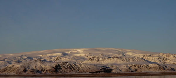 Scenic view of snowcapped mountains against clear sky