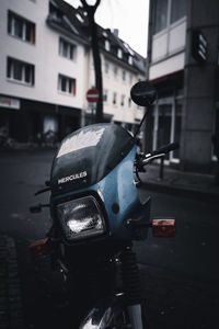 Close-up of bicycle on road in city