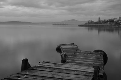 Pier on lake against sky