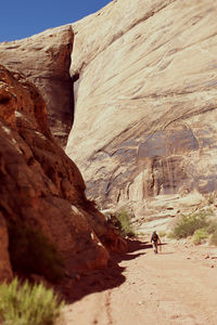 Tourists walking on rock