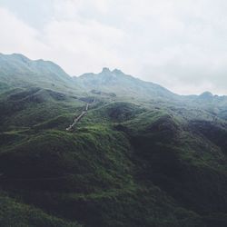 Scenic view of mountains against cloudy sky