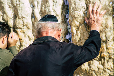 Rear view of man with arms raised