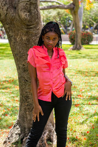 Portrait of young woman standing in park
