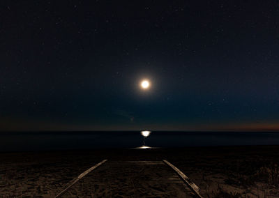 Scenic view of sea against full moon at night