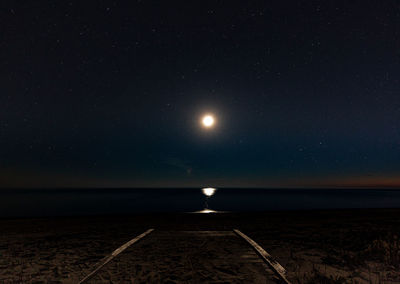 Scenic view of sea against sky at night