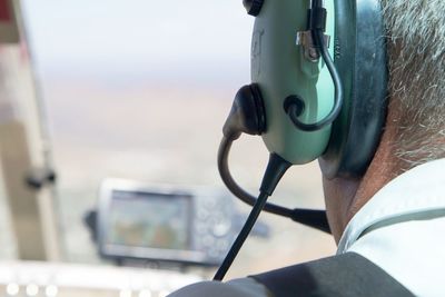 Close-up of pilot wearing headphones