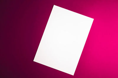 High angle view of paper against colored background