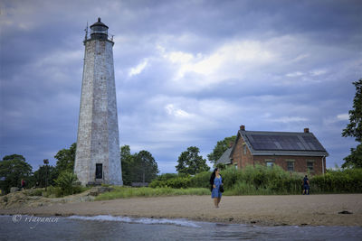 Man standing by historic building against sky