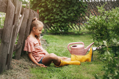 Girl sitting in yard