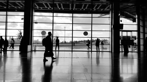 Silhouette people walking at airport