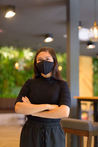 Portrait of young woman standing outdoors