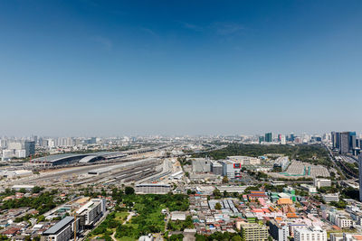 High angle view of city buildings against clear sky