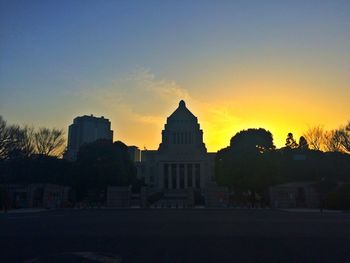 Buildings against sky at sunset