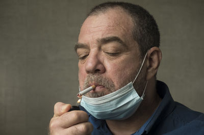 Close-up portrait of man holding camera