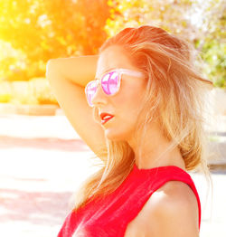 Close-up of young woman wearing sunglasses during sunny day