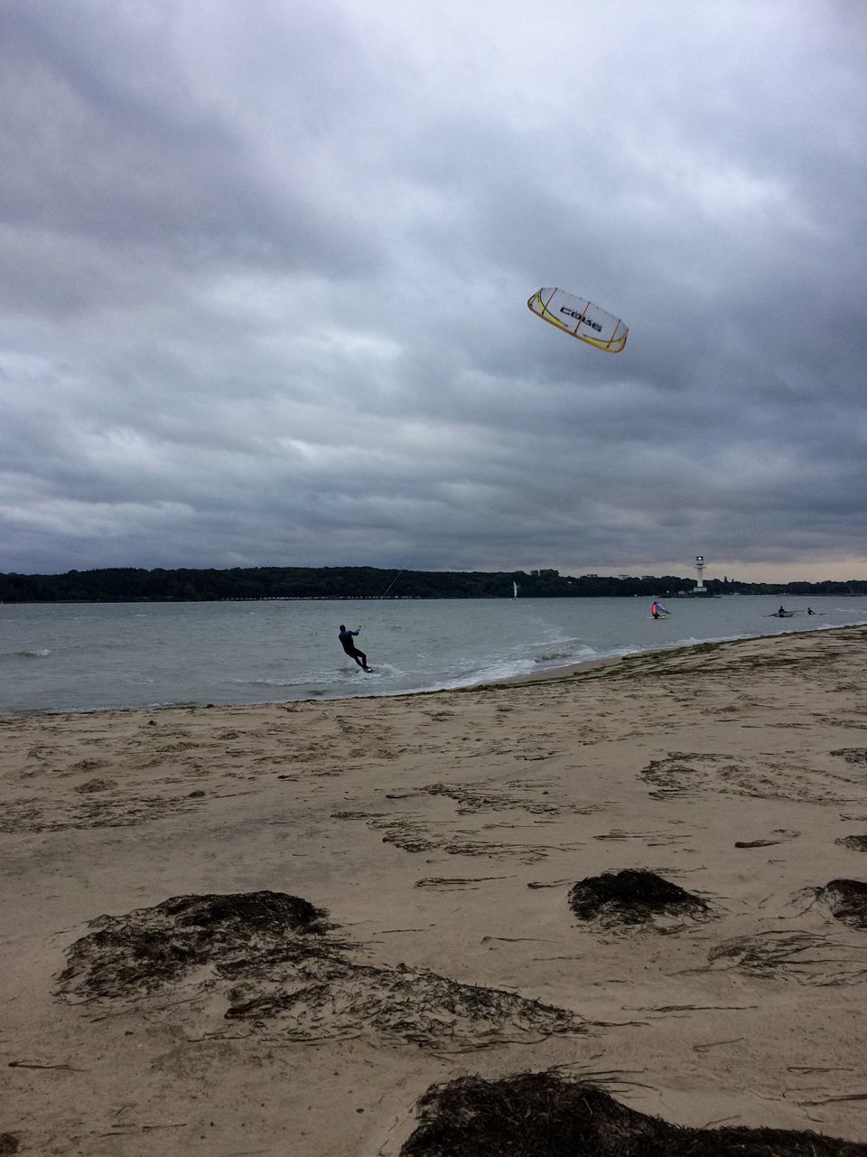 beach, sea, sand, cloud - sky, horizon over water, sky, outdoors, nature, vacations, scenics, kiteboarding, water, parachute, day, adventure, extreme sports, beauty in nature, one person, paragliding, people