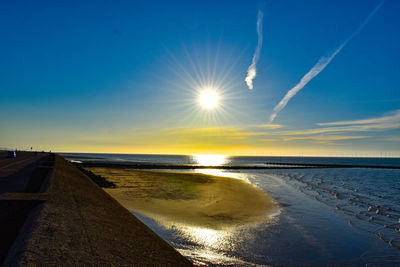 Scenic view of sea against sky at sunset