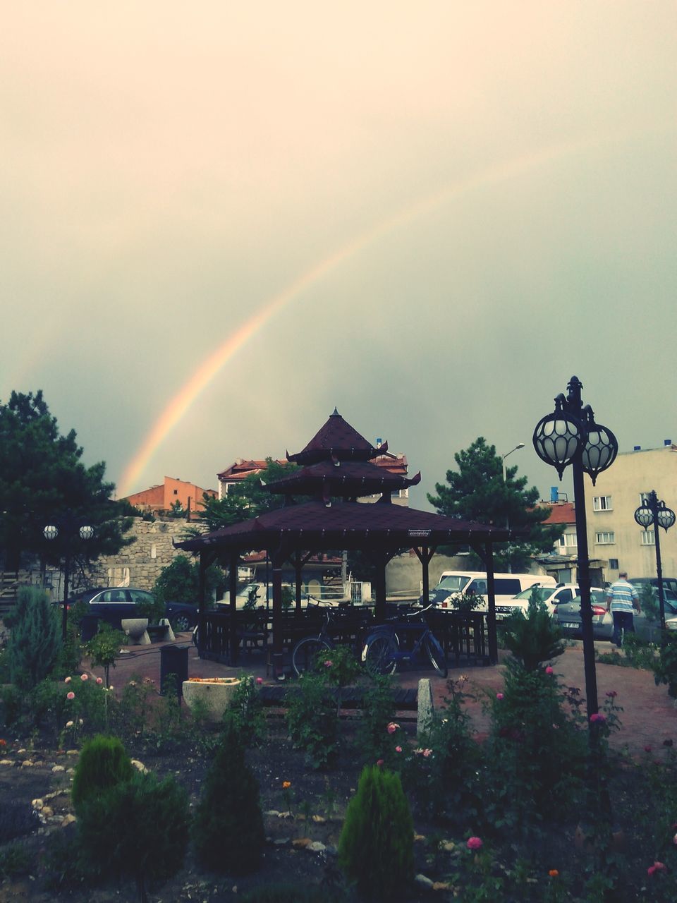 sky, tree, built structure, architecture, rainbow, building exterior, cloud - sky, nature, house, dusk, beauty in nature, scenics, illuminated, weather, outdoors, street light, sunset, tranquility, multi colored, no people