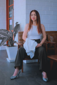 Portrait of a young woman sitting on seat