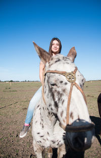 Portrait of argentinian female teenager riding horse